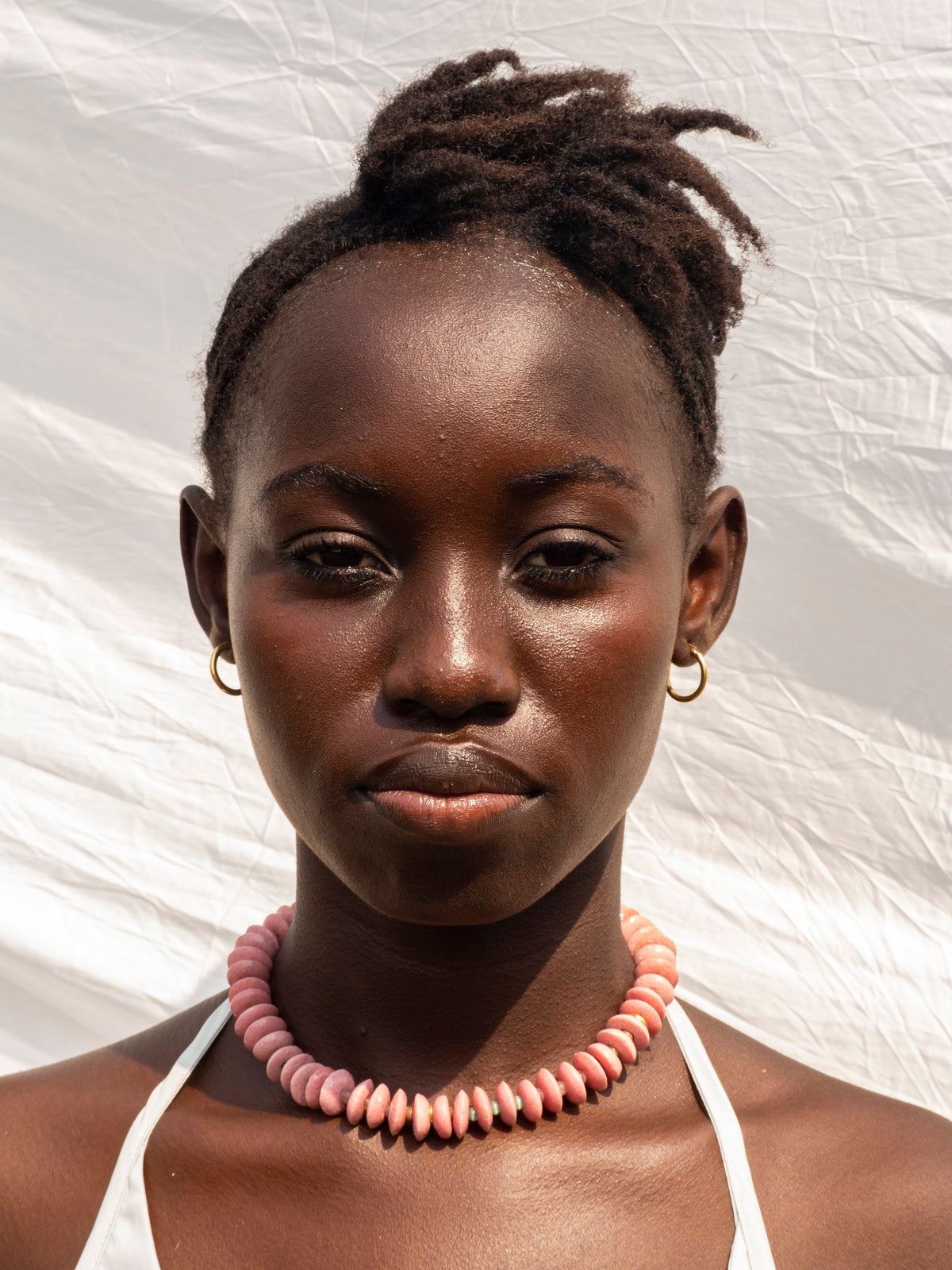 Elegant statement necklace featuring hand-selected vibrant beads and sustainable gold-plated brass.