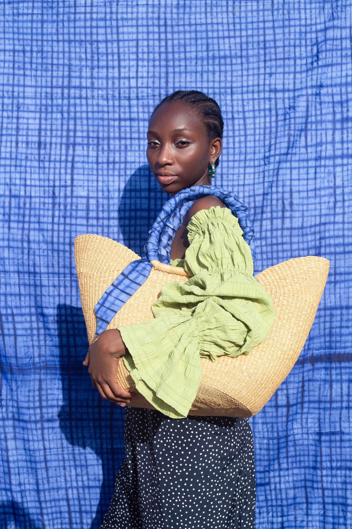 Handcrafted Ghanaian tote bag with a unique blend of woven fibers and tie-dye fabric