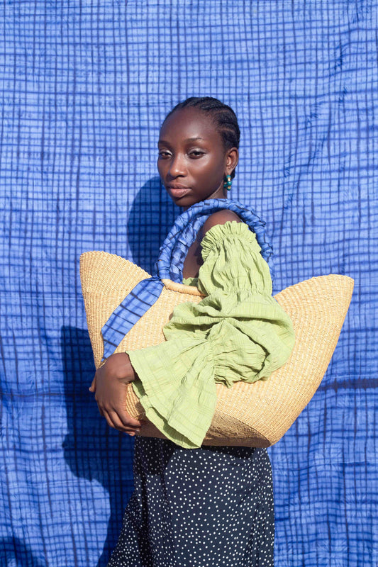 Handcrafted Ghanaian tote bag with a unique blend of woven fibers and tie-dye fabric