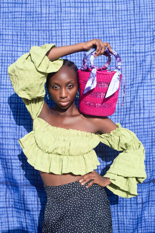Handcrafted fuchsia hand bag made in Ghana.