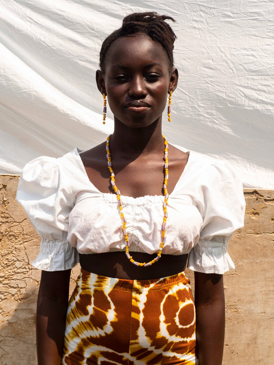 Contemporary artisan necklace with bold Ghanaian beads and refined gold accents, perfect for special occasions.