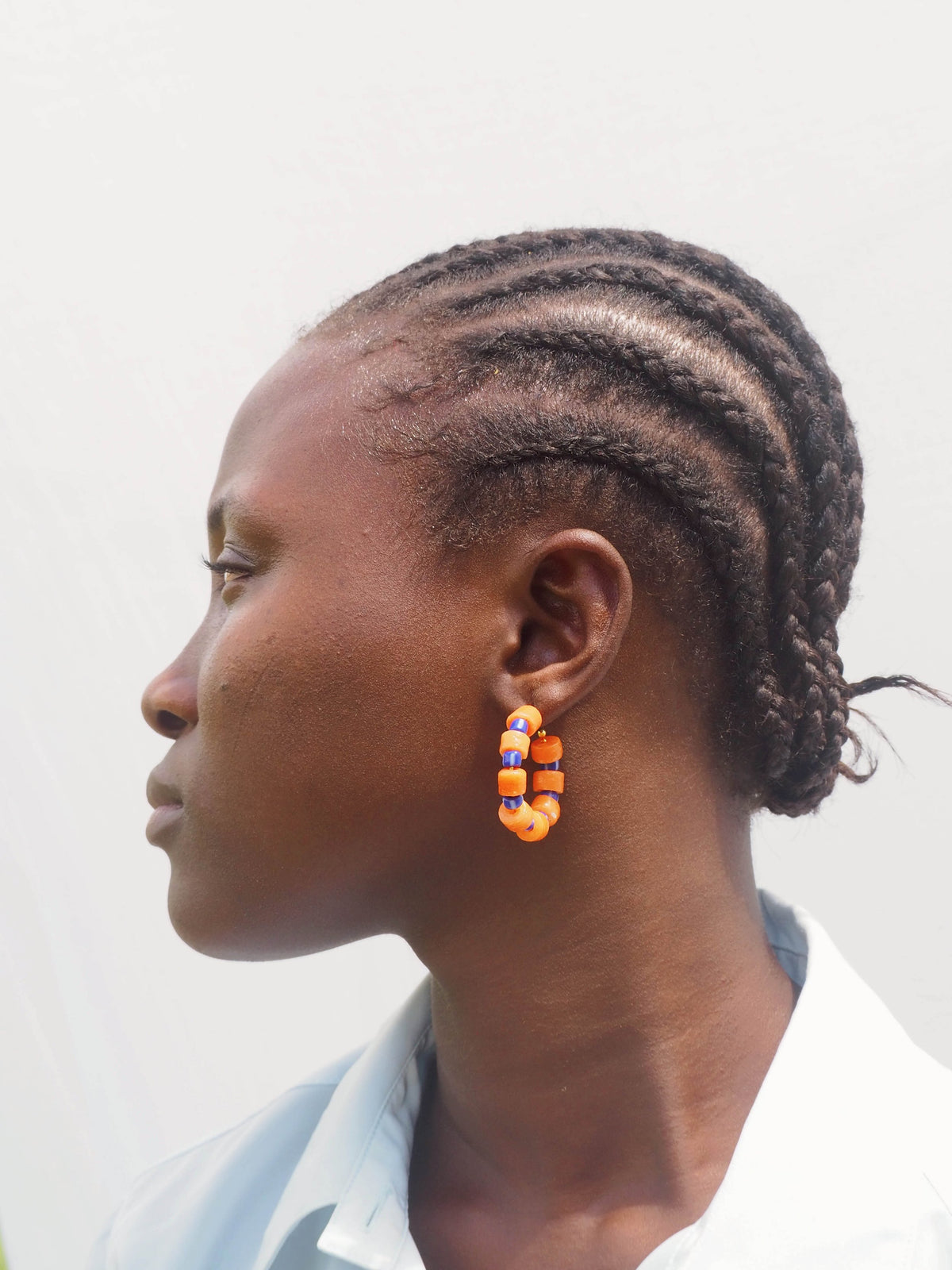 Boho-inspired earrings with recycled glass beads and gold-plated brass hoops.