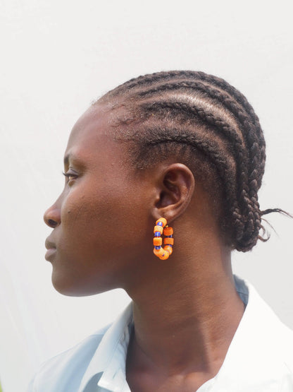 Boho-inspired earrings with recycled glass beads and gold-plated brass hoops.