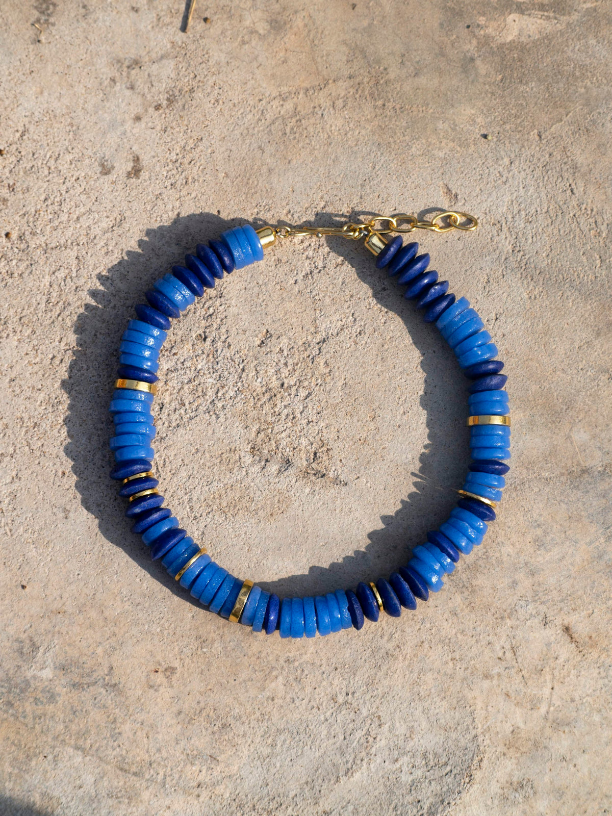 Modern Ghanaian necklace with striking, colorful recycled glass beads and a gold-plated chain.
