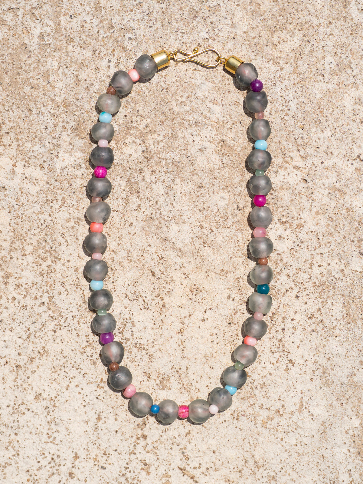 Minimalist artisan necklace with handcrafted glass beads and a gold-plated details.