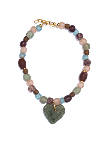 Statement necklace featuring Ghanaian heart-shaped recycled glass beads on a strand of unique red beads, combining vibrant colors and cultural craftsmanship.