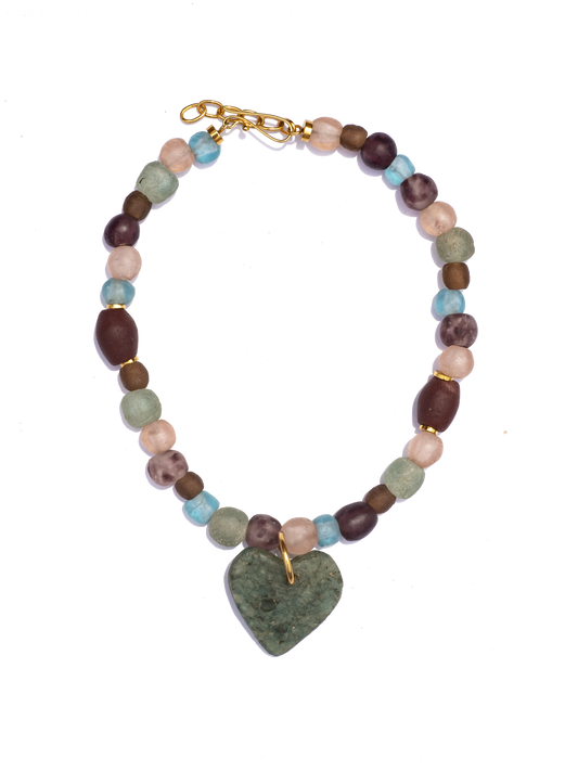 Statement necklace featuring Ghanaian heart-shaped recycled glass beads on a strand of unique red beads, combining vibrant colors and cultural craftsmanship.
