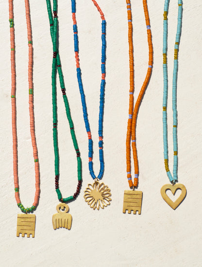 Handcrafted beaded necklace with vibrant Ghanaian glass beads and gold-plated Adinkra symbol amulets.