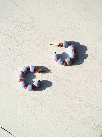 Boho-inspired earrings with recycled glass beads and gold-plated brass hoops.