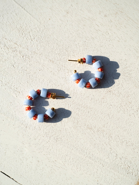 Boho-inspired earrings with recycled glass beads and gold-plated brass hoops.
