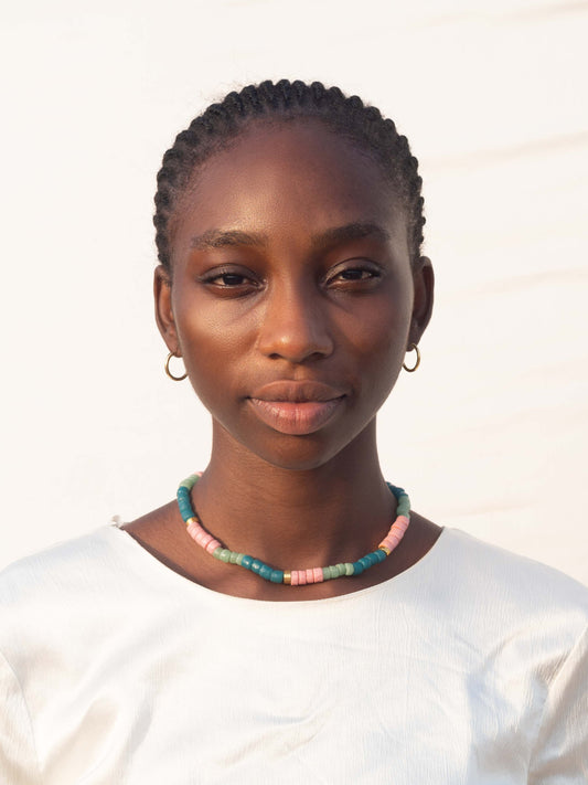 Modern African heritage jewelry featuring colorful handmade Ghanaian glass beads and elegant gold-plated accents, blending tradition with contemporary style.