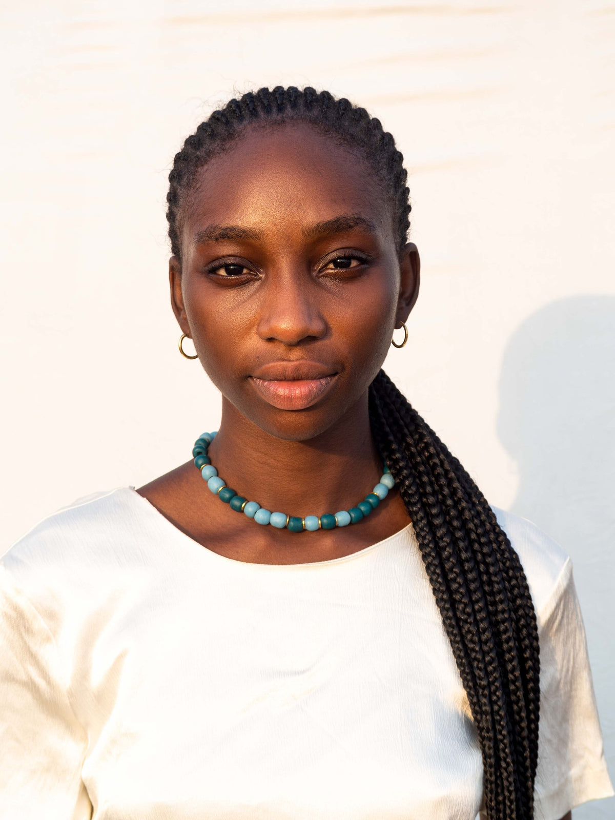 Handmade necklace with colorful recycled glass beads and gold-plated brass details made in Ghana