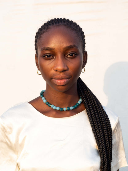 Handmade necklace with colorful recycled glass beads and gold-plated brass details made in Ghana
