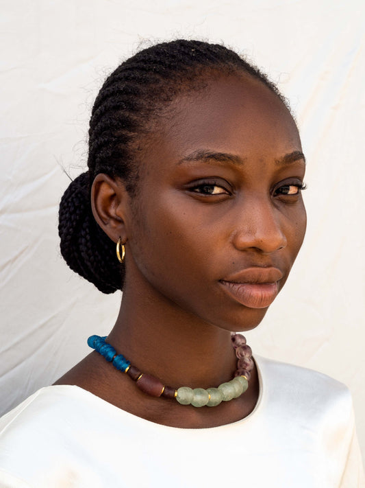 Elegant statement necklace featuring hand-selected vibrant beads and sustainable gold-plated brass.