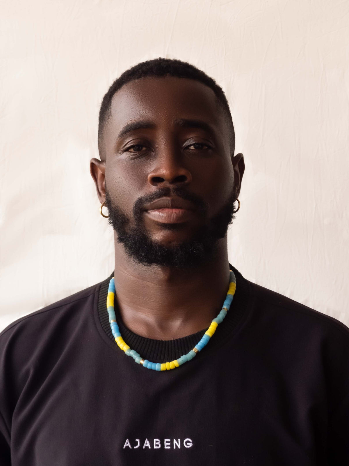 Modern African heritage jewelry featuring colorful handmade Ghanaian glass beads and elegant gold-plated accents, blending tradition with contemporary style.