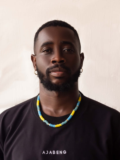 Modern African heritage jewelry featuring colorful handmade Ghanaian glass beads and elegant gold-plated accents, blending tradition with contemporary style.