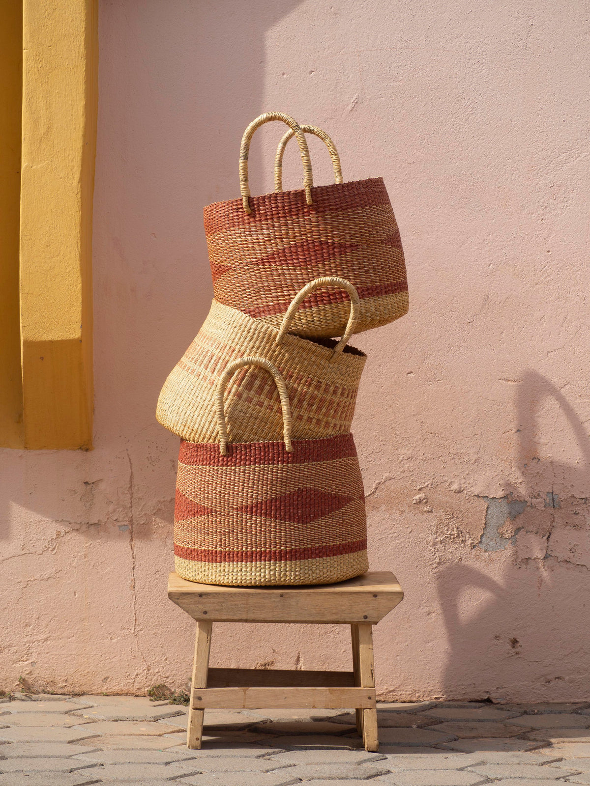 Handwoven basket with a geometric pattern in earthy tones.