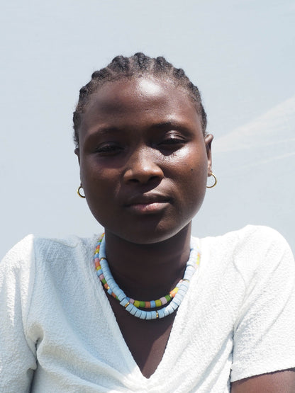 Handcrafted Ghanaian necklace with vibrant recycled glass beads and delicate gold-plated accents.